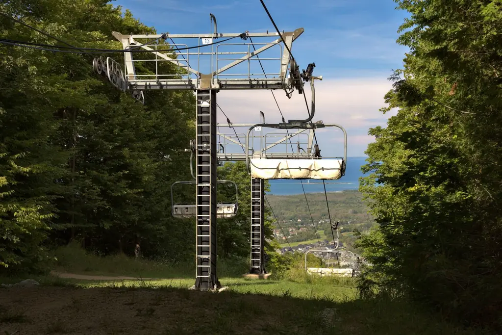 View of a ski lift in Blue Mountain, Ontario amidst lush greenery
