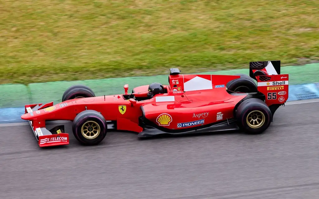 Red Formula 1 car on a racing circuit