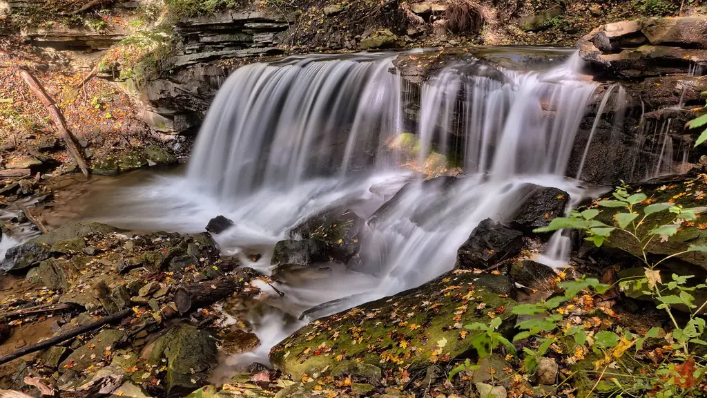 Waterfall flowing over rocks in an autumn forest in Hamilton, Canada