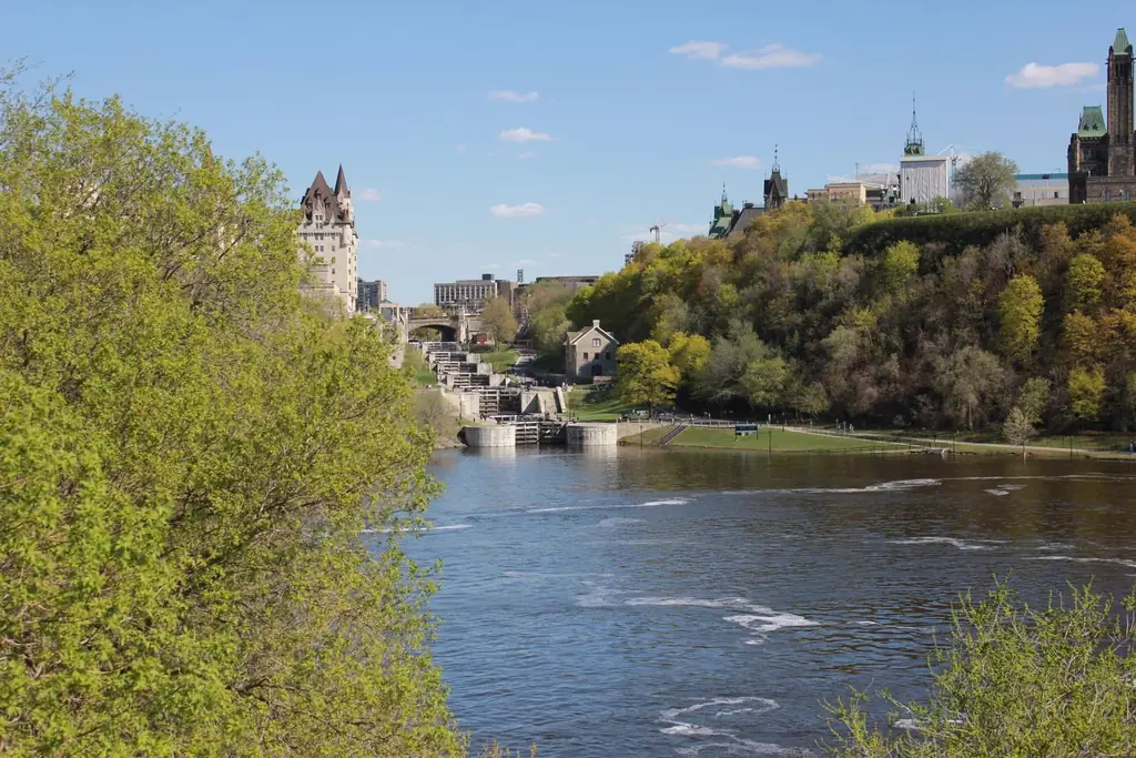 Spring view of Ottawa's Rideau Canal Locks with lush greenery and historical architecture