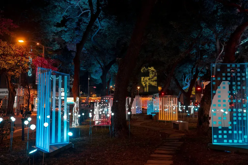 Colorful illuminated art installation in an urban park at night