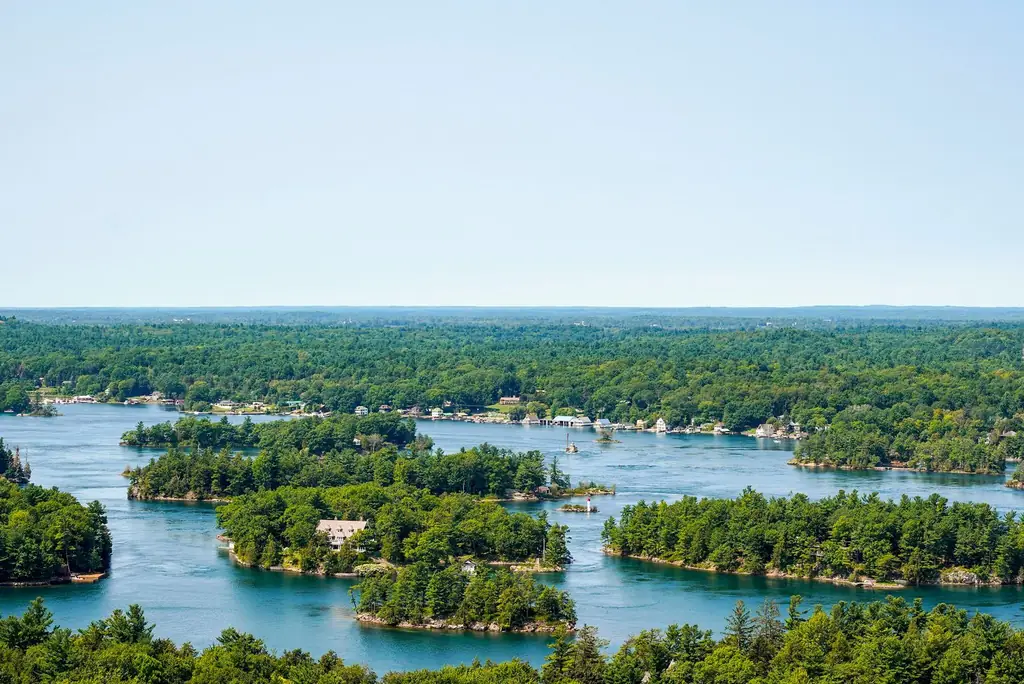 Aerial view of Thousand Islands with lush green forests and shimmering water in Ontario, Canada