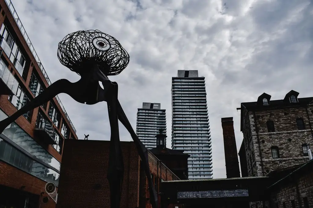 Sculpture set against the urban skyline of Toronto's Distillery District
