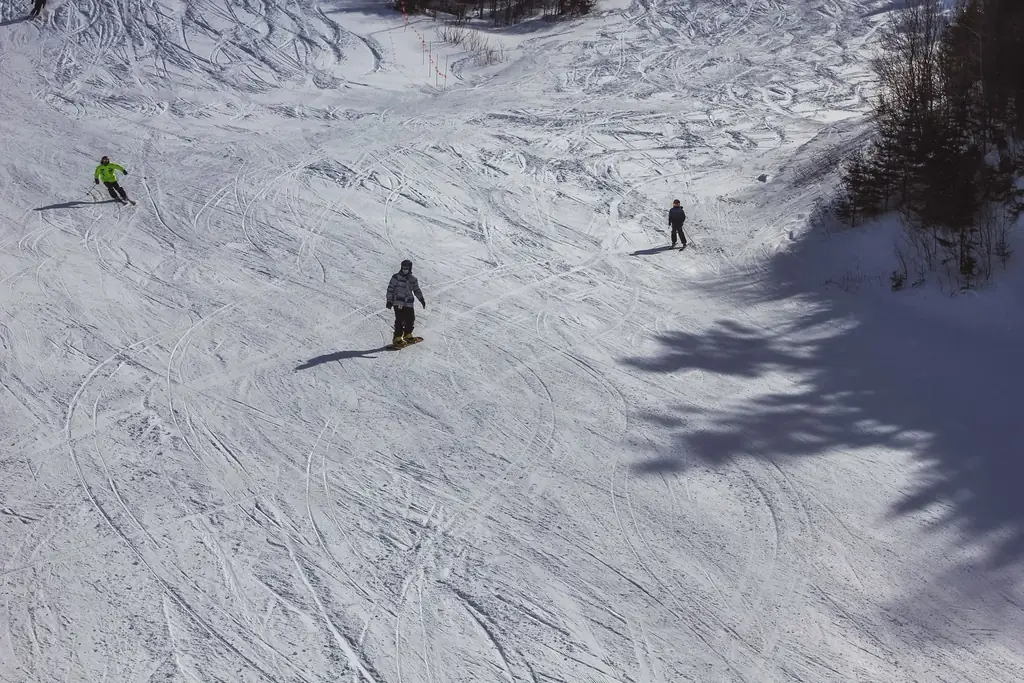 Skiers descending the snowy slopes at Mont-Tremblant, Canada