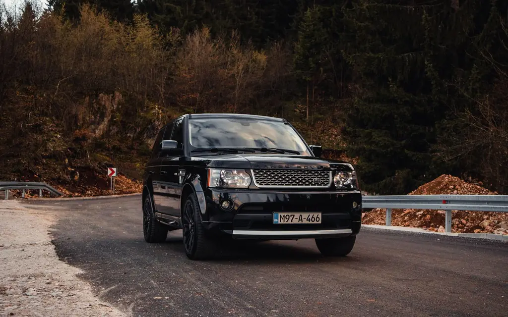 Black luxury SUV on a mountain road
