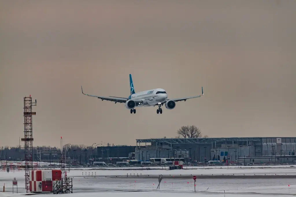 Airliner on final approach over a snowy airfield