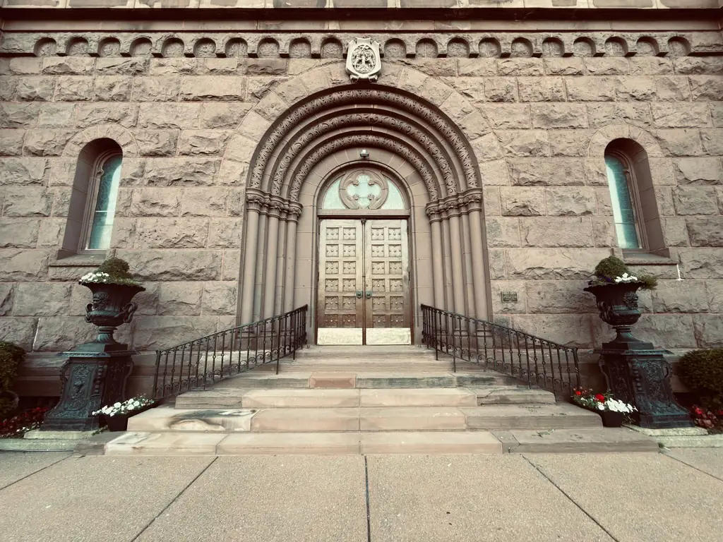 Ornate stone building entrance with arched doorway and intricate architectural details in Buffalo