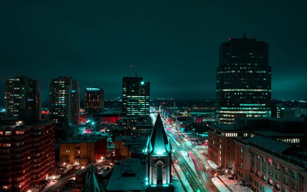 Aerial night view of London, Ontario's downtown with vibrant light trails and illuminated buildings