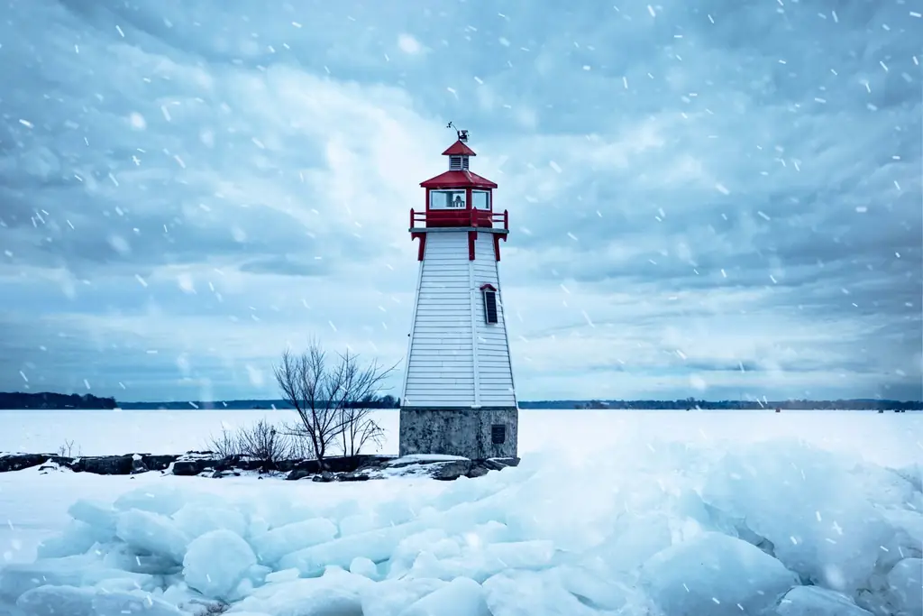 Lighthouse stands amidst snow and ice during a winter storm at Lake Simcoe, Ontario