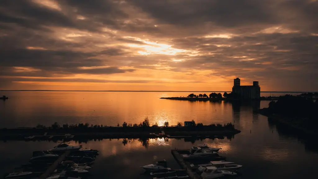 Sunrise view over Collingwood Harbor with boats and reflections on the water