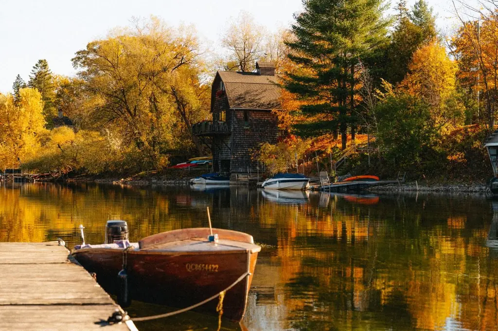 Autumn scene with a house and boats on a lake in North Hatley, Québec