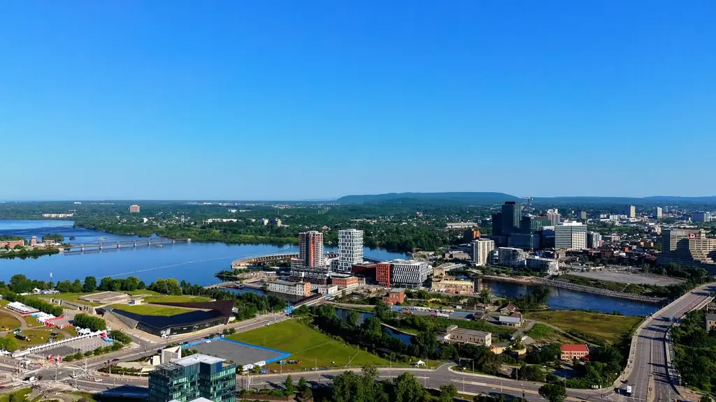 Aerial view of the Ottawa River and Gatineau cityscape under a clear blue sky