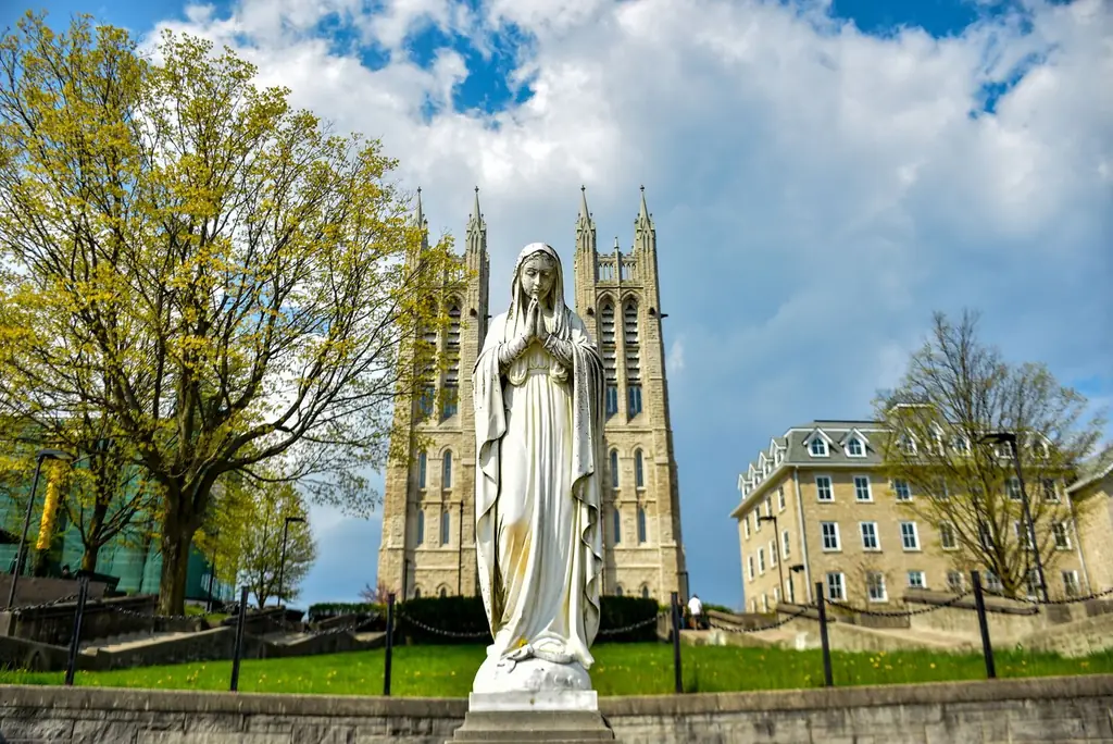 Gothic architecture of St. Mary's Church with a Virgin Mary statue in Guelph, Canada