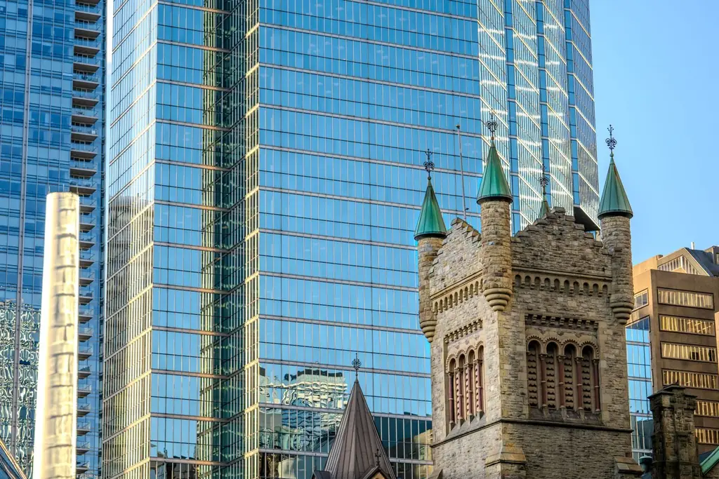 St. Andrew's Church tower against glass towers on King Street West
