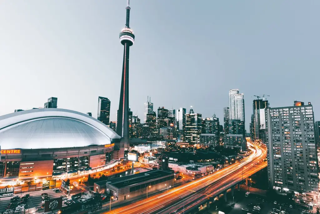 View of Toronto's skyline with CN Tower illuminated at dusk