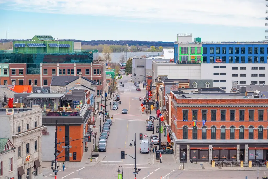 Aerial view of Kingston's bustling downtown with colorful architecture on a bright day