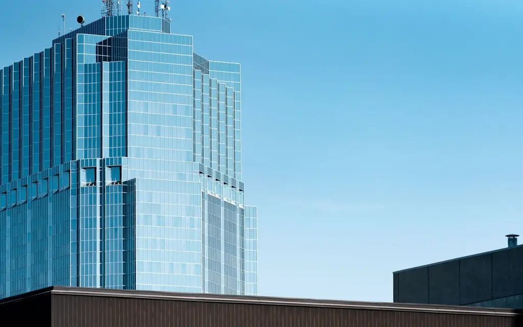 Contemporary glass facade building in London, Ontario, under a clear blue sky