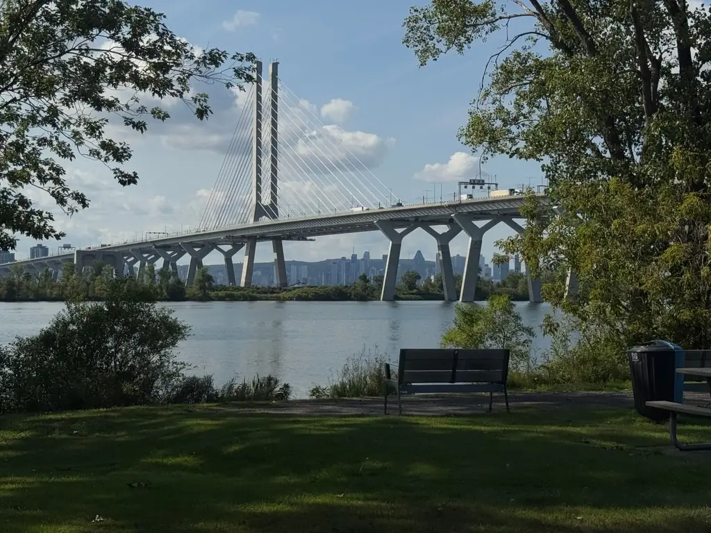 A sunny day view of the iconic Samuel De Champlain Bridge over the St. Lawrence River in Montreal