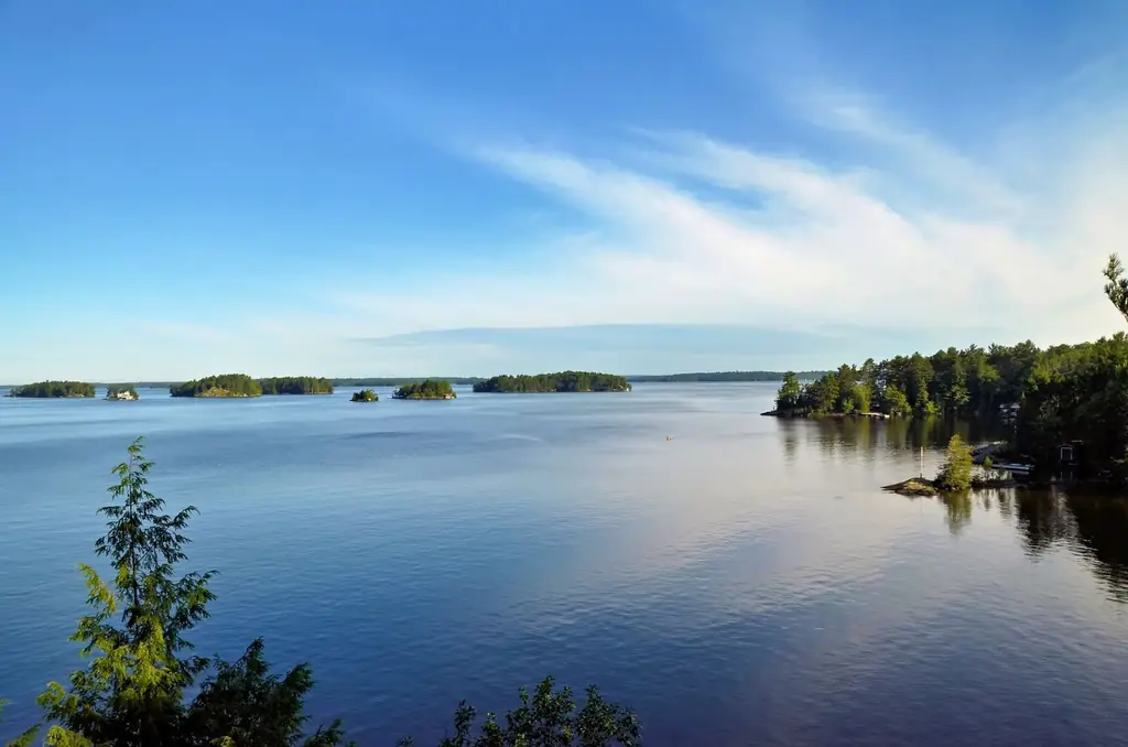 View of Muskoka Lakes with clear blue skies and lush greenery