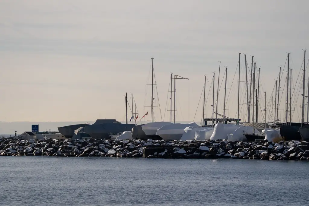 Marina with snow-covered boats and masts in Oakville, Ontario