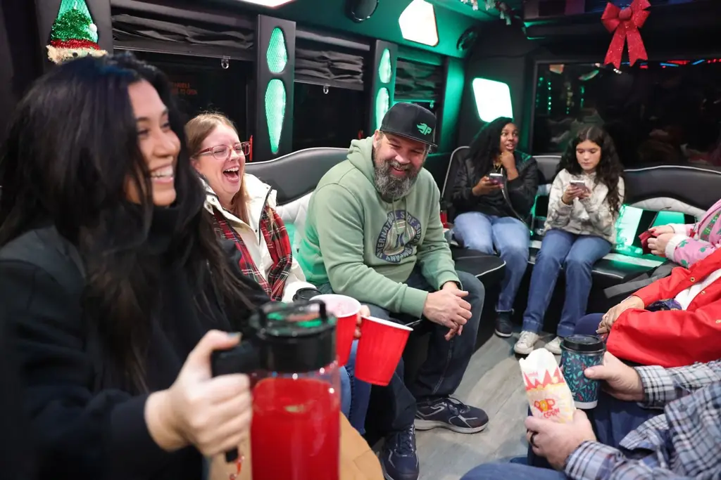 A joyful group of friends enjoying a festive holiday celebration inside a colorful party bus
