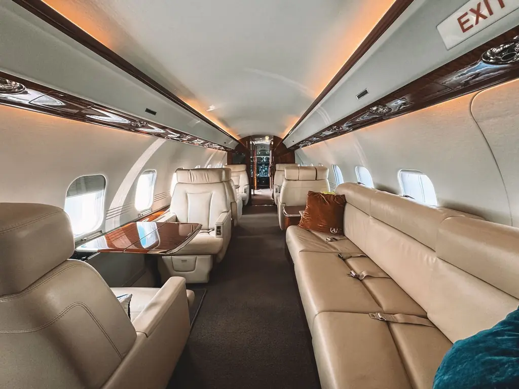 Luxury of a private jet interior featuring leather seats and wooden trim