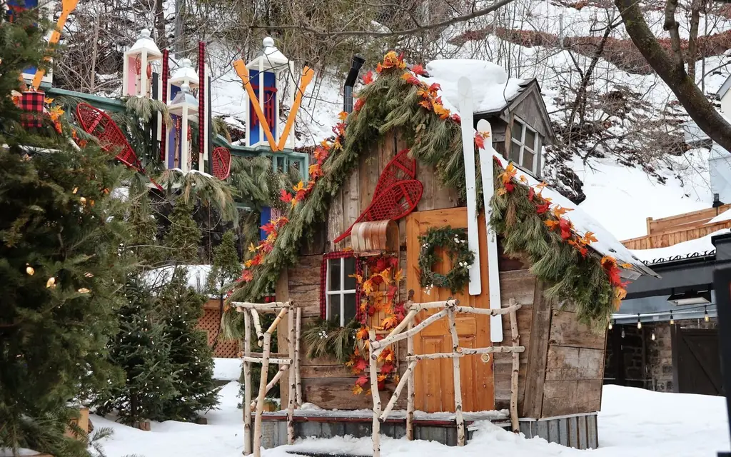 Rustic cabin adorned with winter decorations and snow