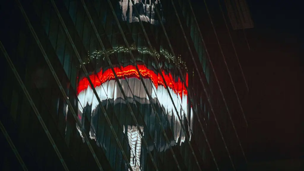 Abstract reflection of the CN Tower in Toronto on a glass skyscraper at night