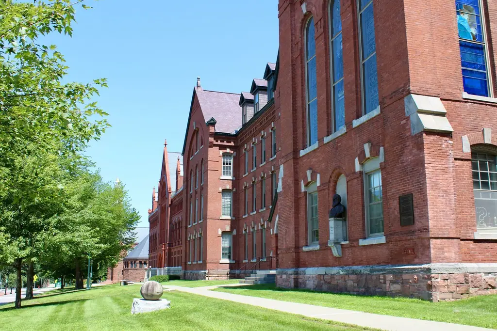 A gothic architectural brick exterior of a Vermont university building on a sunny day
