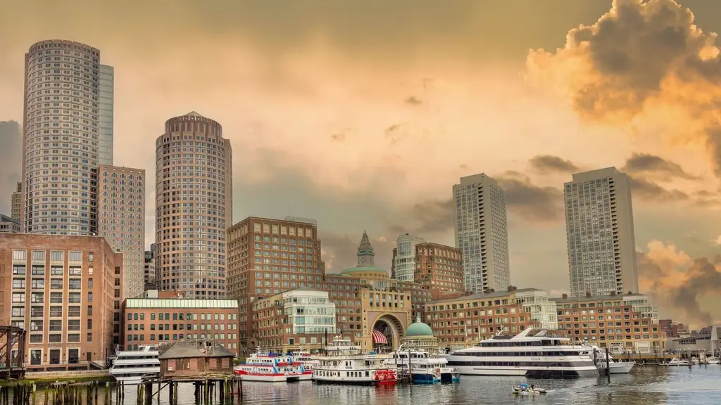 View of Boston Harbor with skyscrapers and boats at sunset