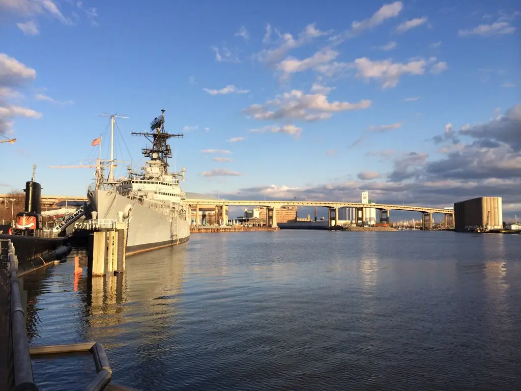 USS Little Rock docked at Buffalo waterfront, with city bridge skyline and serene waters