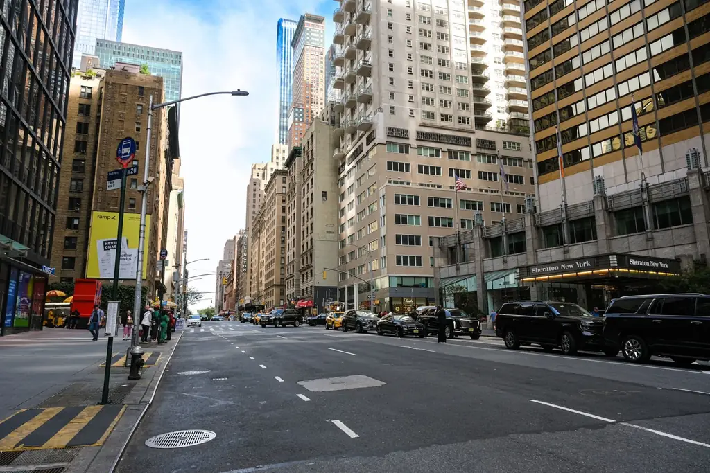 Urban cityscape of Midtown Manhattan with skyscrapers, vehicles, and pedestrians